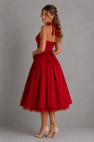Red dress with a halter neck and full skirt on a gray background