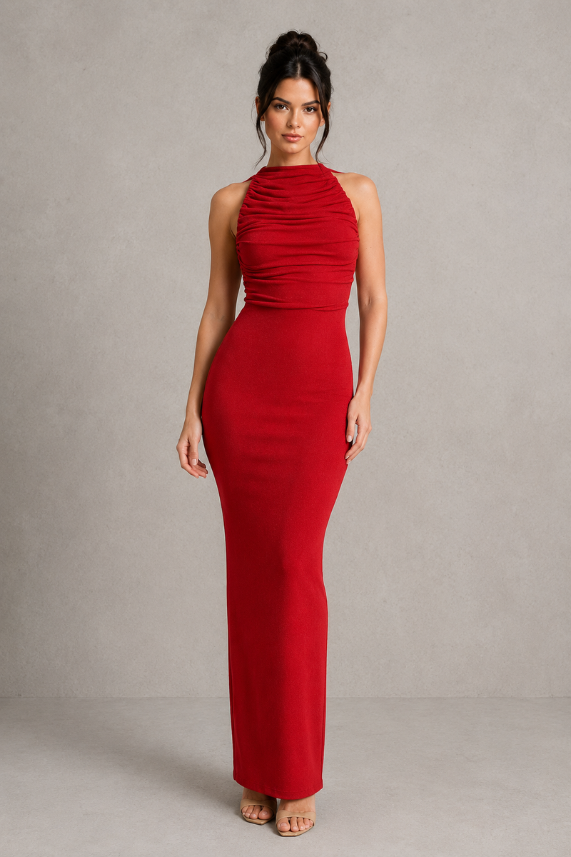 Woman wearing a red halter neck dress against a plain background