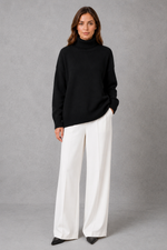Women’s high neck knit jumper with a relaxed loose fit, cosy turtleneck, long sleeves and soft knitted finish for autumn and winter.