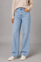 Women’s high waisted wide leg jeans in light wash denim with a relaxed straight leg, classic five-pocket design and button-and-zip fastening.