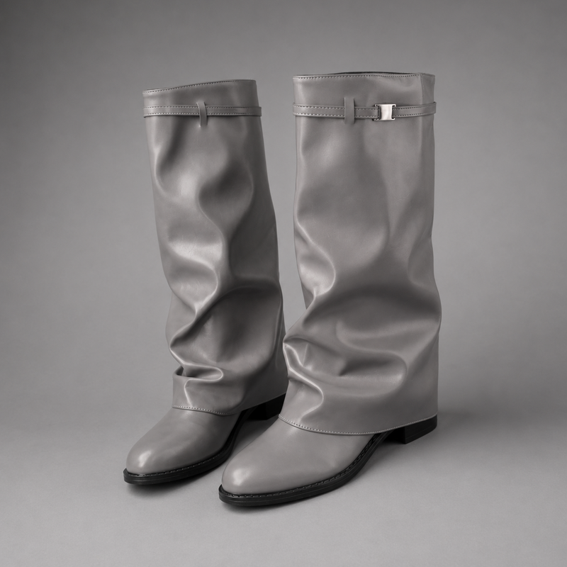 Women’s knee-high slouch boots with pointed toe, low block heel and metal cuff detail.