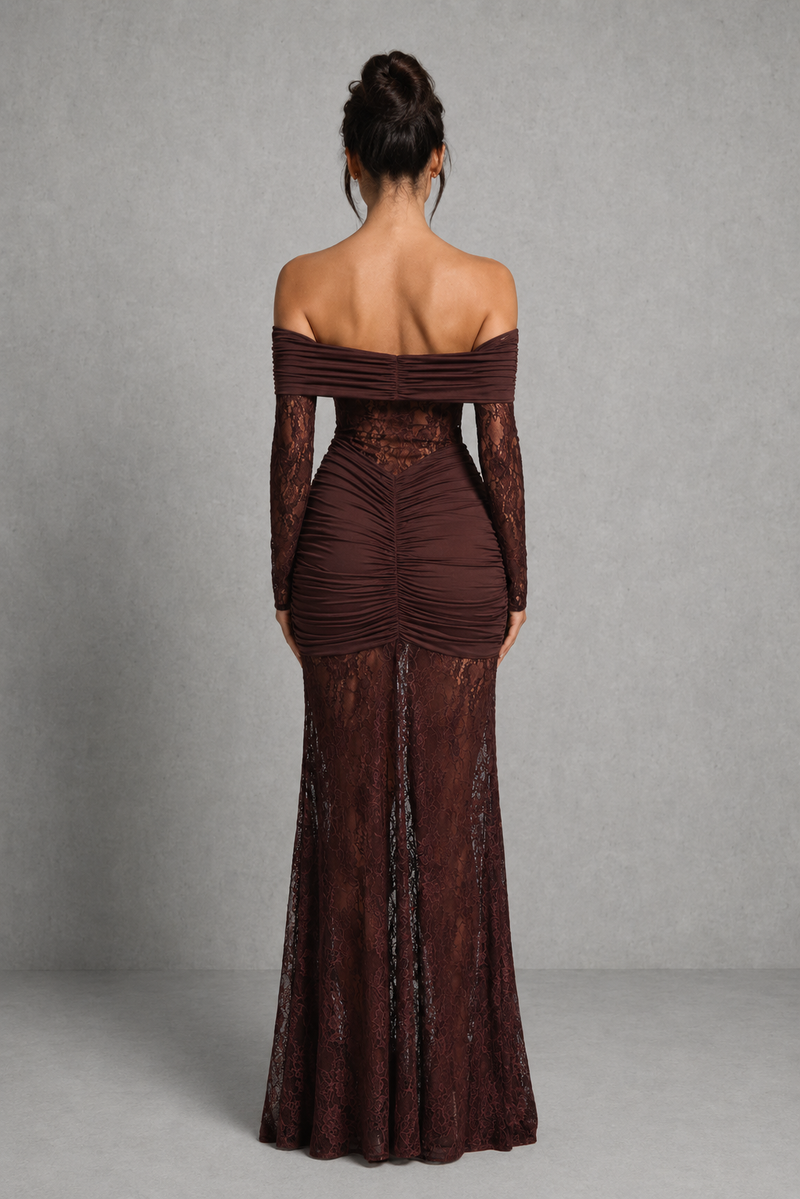 Woman wearing a brown off-shoulder evening gown with long sleeves on a gray background