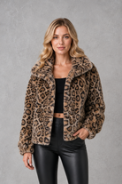 Women's leopard print faux fur cropped jacket with long sleeves, relaxed fit and soft plush texture, styled as a warm and lightweight winter coat.