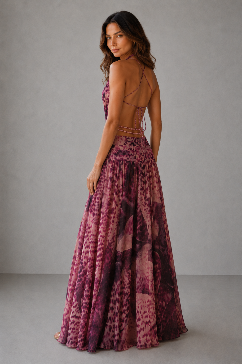 Woman wearing a patterned dress with a plain background