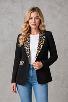 Women's elegant open-front blazer with leopard print lapels and pocket flap detailing, featuring a tailored hip-length fit for work and smart casual occasions.