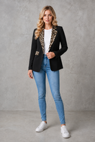 Women's elegant open-front blazer with leopard print lapels and pocket flap detailing, featuring a tailored hip-length fit for work and smart casual occasions.