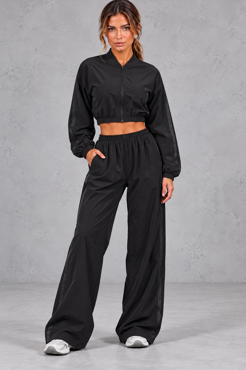Women's black cropped zip-up jacket and wide leg trouser fitness set – front view