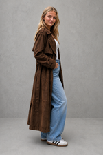 Women's long velvet trench coat in a luxurious soft velvet fabric with a longline silhouette, adjustable belted waist and elegant tailored fit, ideal for autumn and winter occasions.