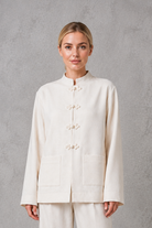 Women's white mandarin collar tailored jacket with a relaxed fit, clean front fastening and structured silhouette, ideal for smart casual, office and formal wear.