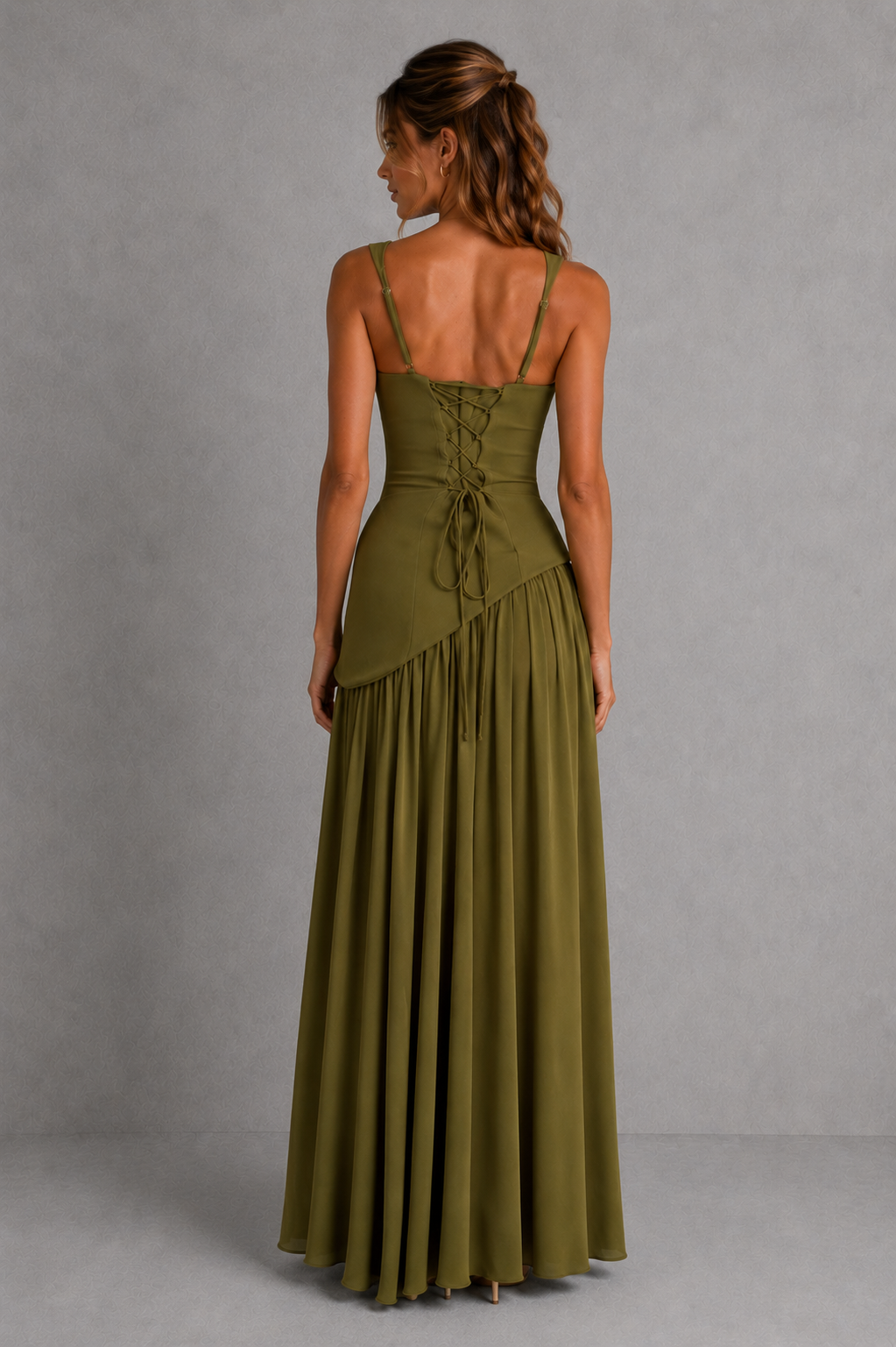 Woman wearing a green dress with a gray background