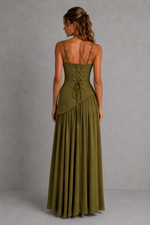 Woman wearing a green dress with a gray background