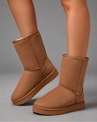 Women's mid-calf faux sheepskin winter boots with a soft cotton upper, corduroy shaft, plush lining, round toe and lightweight flat sole in a slip-on design for warm everyday winter comfort.