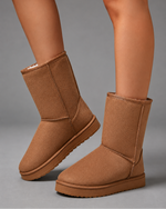 Women's mid-calf faux sheepskin winter boots with a soft cotton upper, corduroy shaft, plush lining, round toe and lightweight flat sole in a slip-on design for warm everyday winter comfort.