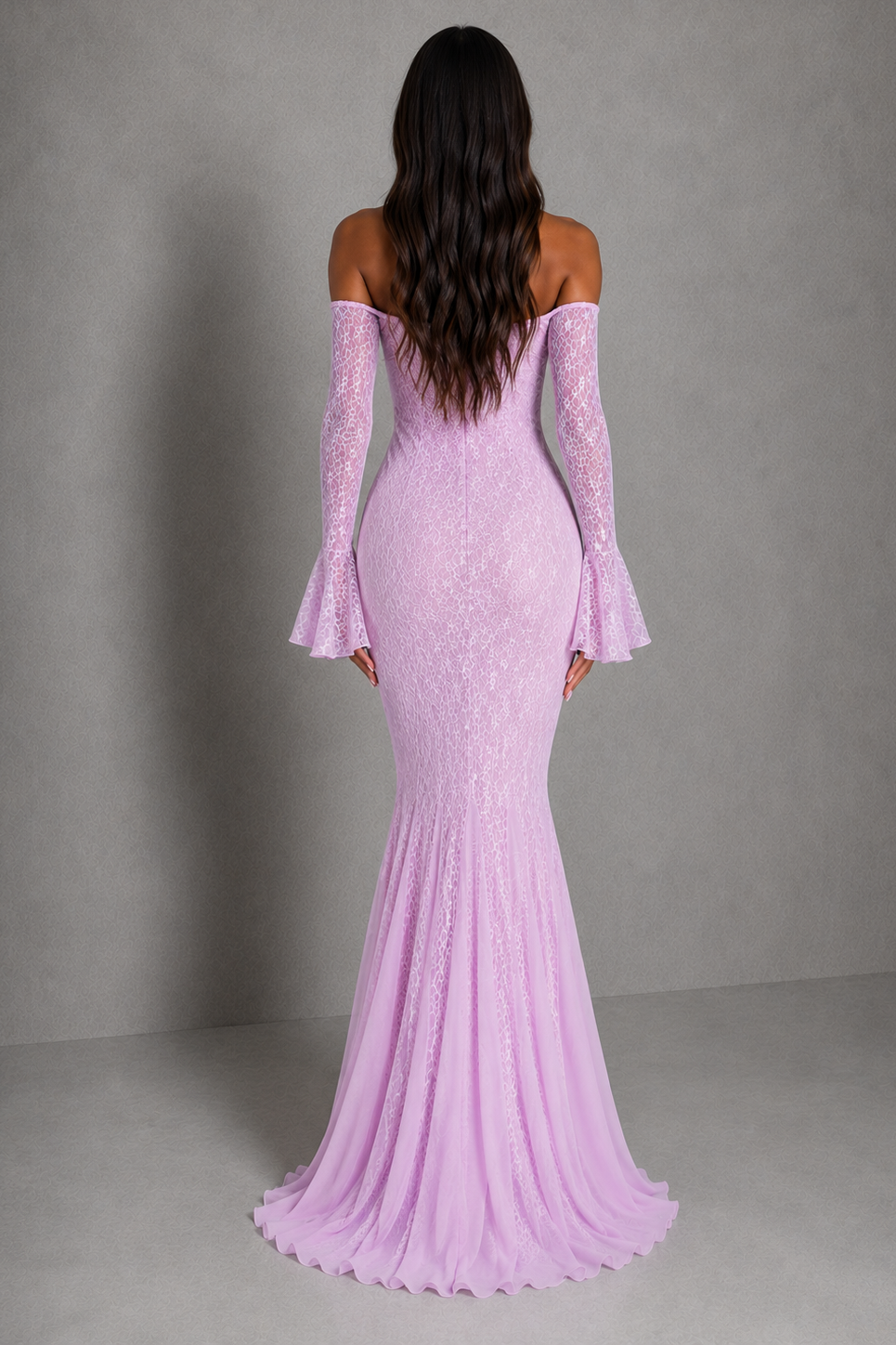 A woman viewed from the back wearing a lavender off-the-shoulder mermaid gown with long flared sleeves and a fitted lace-embroidered bodice, photographed against a plain gray studio backdrop.