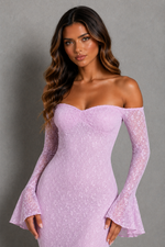 A woman modeling an off-the-shoulder lavender lace dress with long flared bell sleeves against a neutral gray studio background.