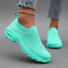 Women's orthopaedic slip-on trainers with a breathable stretch-knit upper, chunky cushioned sole and lightweight design, offering all-day comfort for walking, commuting, travel and everyday casual wear.