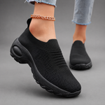Women's orthopaedic slip-on trainers with a breathable stretch-knit upper, chunky cushioned sole and lightweight design, offering all-day comfort for walking, commuting, travel and everyday casual wear.