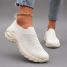 Women's orthopaedic slip-on trainers with a breathable stretch-knit upper, chunky cushioned sole and lightweight design, offering all-day comfort for walking, commuting, travel and everyday casual wear.