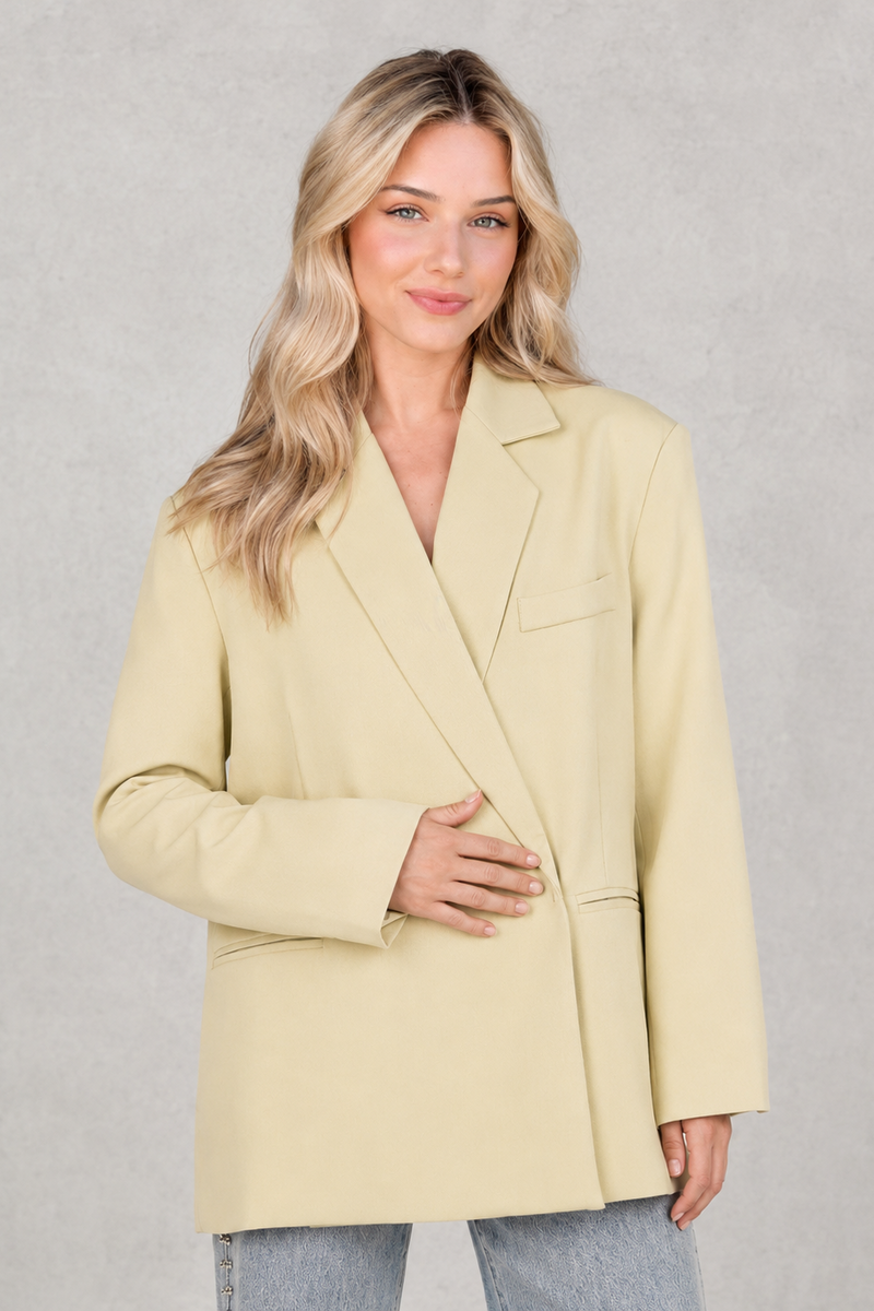 Women's oversized asymmetrical blazer with a relaxed fit, structured shoulder pads, asymmetrical front button fastening and side slits, ideal for smart-casual workwear and everyday layering.
