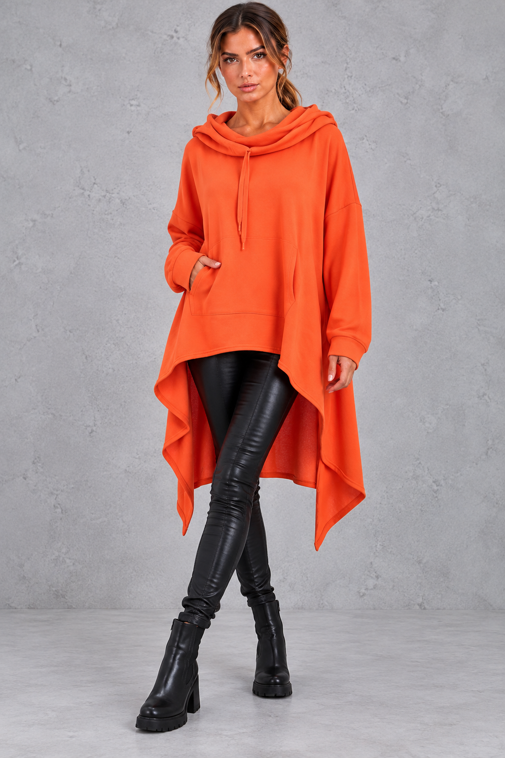 Women's orange oversized hoodie with asymmetric hanky hem – front view