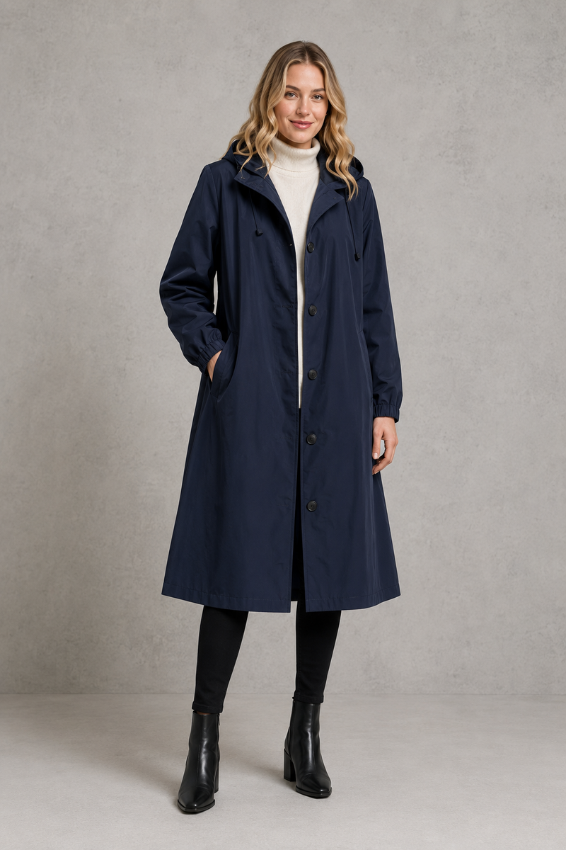 Women's oversized waterproof trench coat with a longline silhouette, adjustable drawstring hood, elasticated cuffs and lightweight water-repellent fabric, ideal for rainy weather and everyday wear.