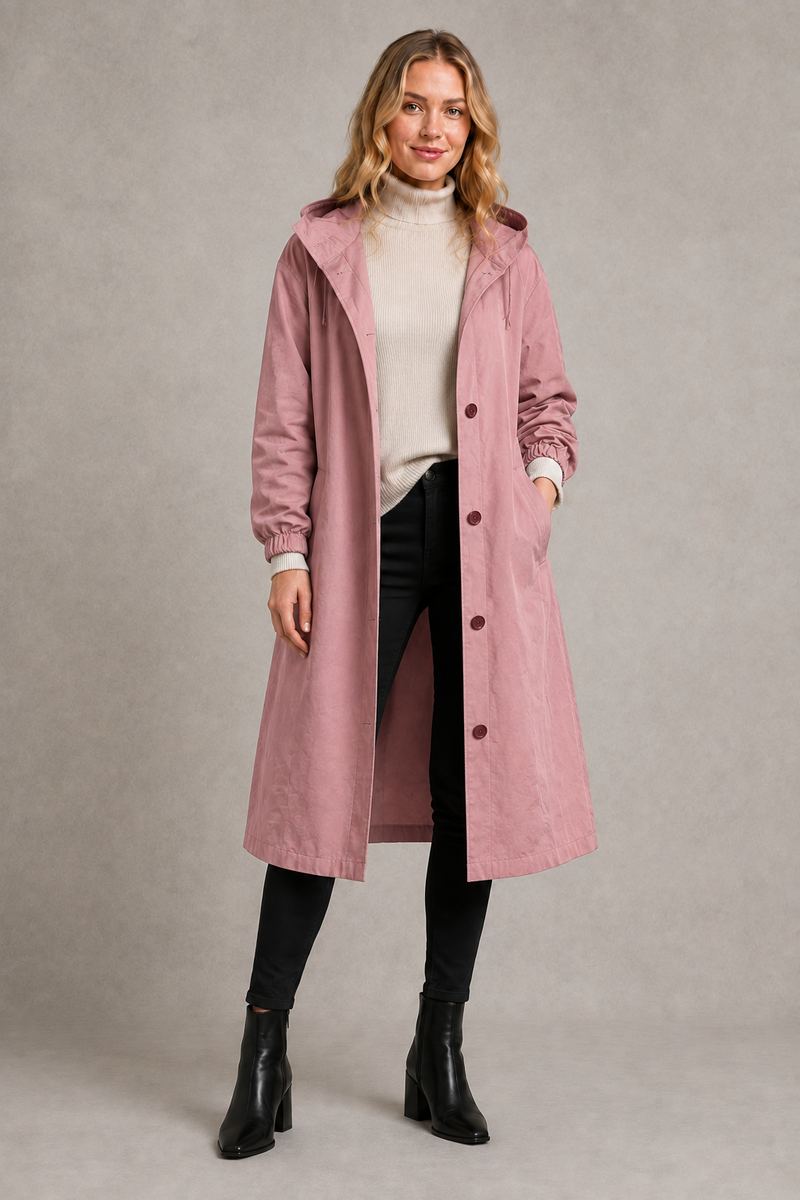 Women's oversized waterproof trench coat with a longline silhouette, adjustable drawstring hood, elasticated cuffs and lightweight water-repellent fabric, ideal for rainy weather and everyday wear.