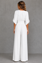 Woman wearing a white dress against a gray background