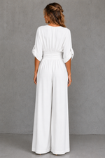 Woman wearing a white dress against a gray background