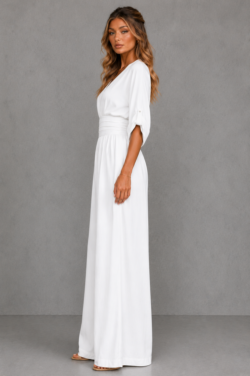 Woman wearing a white dress against a gray background