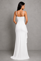 Woman wearing a white evening gown against a gray background