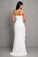 Woman wearing a white evening gown against a gray background
