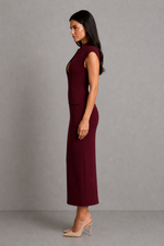 Woman wearing a burgundy dress against a gray background