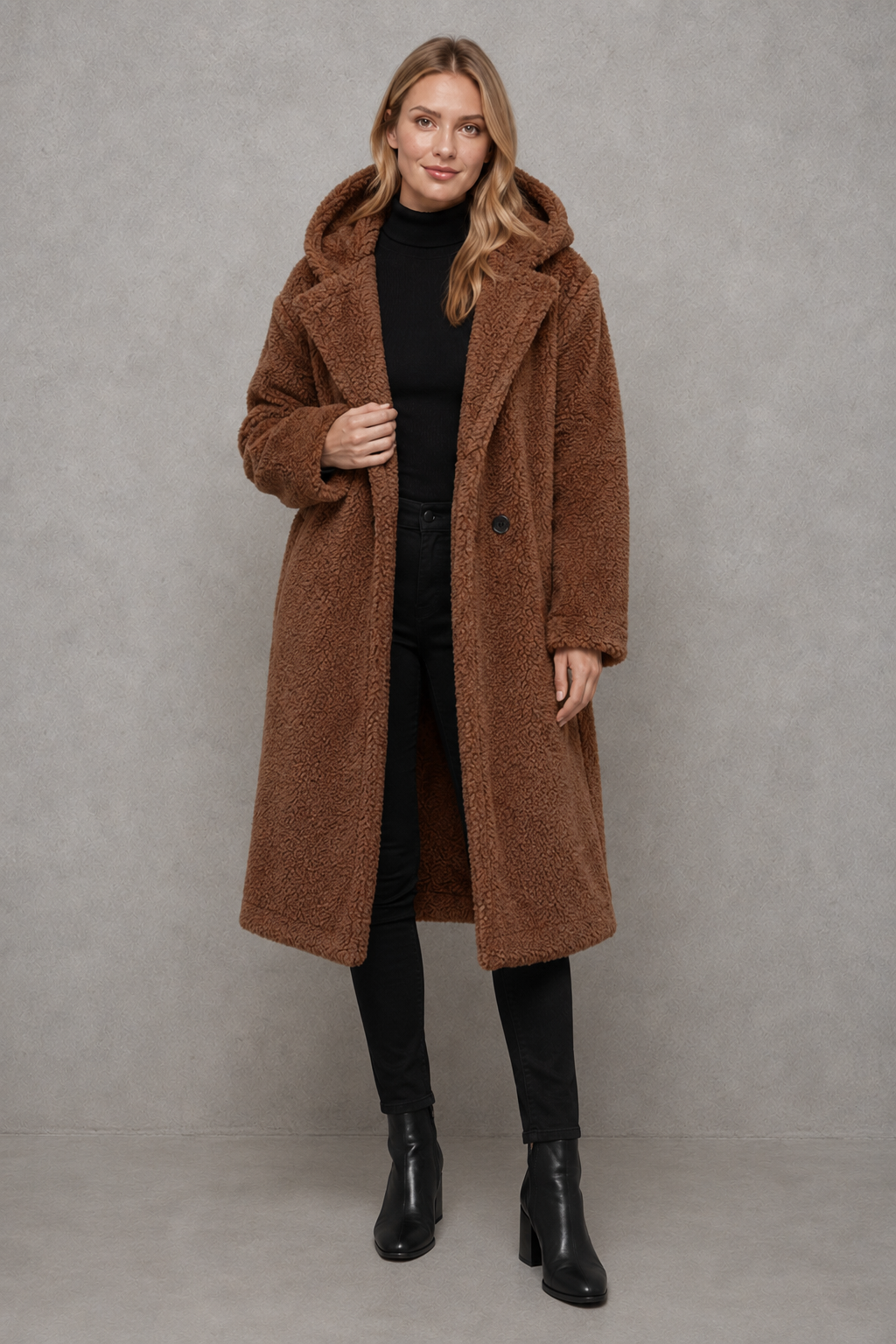 Women's quilted longline coat with a padded design, protective hood, deep side pockets and a relaxed fit, offering warm, lightweight comfort for autumn and winter wear.