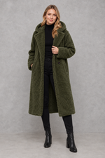 Women's quilted longline coat with a padded design, protective hood, deep side pockets and a relaxed fit, offering warm, lightweight comfort for autumn and winter wear.