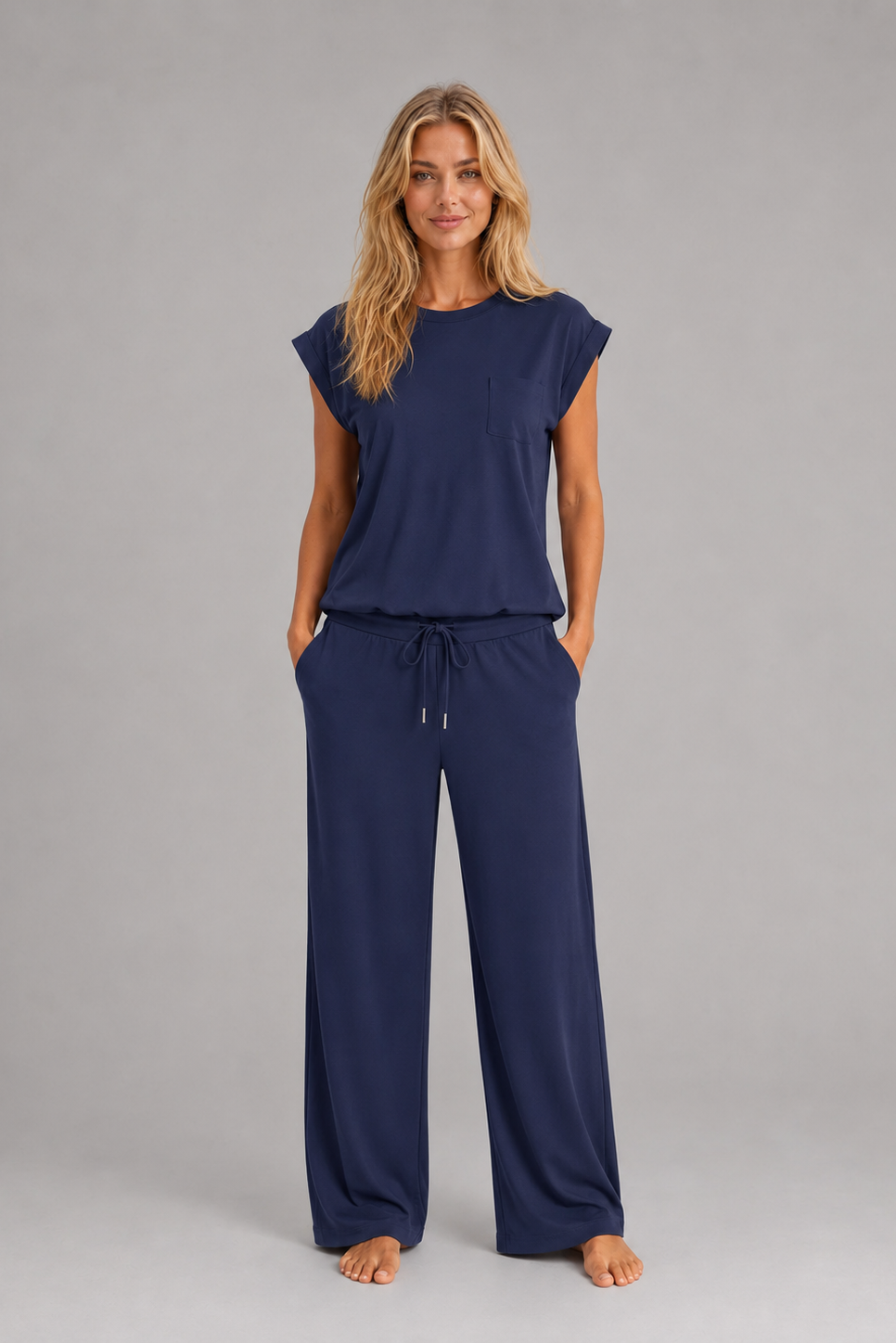 Women's relaxed two-piece lounge set featuring a cap sleeve T-shirt with chest pocket and matching wide leg trousers with an elasticated drawstring waist, crafted from soft breathable fabric for everyday comfort.