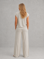 Women's relaxed two-piece lounge set featuring a cap sleeve T-shirt with chest pocket and matching wide leg trousers with an elasticated drawstring waist, crafted from soft breathable fabric for everyday comfort.