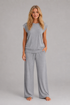 Women's relaxed two-piece lounge set featuring a cap sleeve T-shirt with chest pocket and matching wide leg trousers with an elasticated drawstring waist, crafted from soft breathable fabric for everyday comfort.