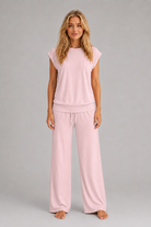 Women's relaxed two-piece lounge set featuring a cap sleeve T-shirt with chest pocket and matching wide leg trousers with an elasticated drawstring waist, crafted from soft breathable fabric for everyday comfort.
