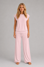 Women's relaxed two-piece lounge set featuring a cap sleeve T-shirt with chest pocket and matching wide leg trousers with an elasticated drawstring waist, crafted from soft breathable fabric for everyday comfort.