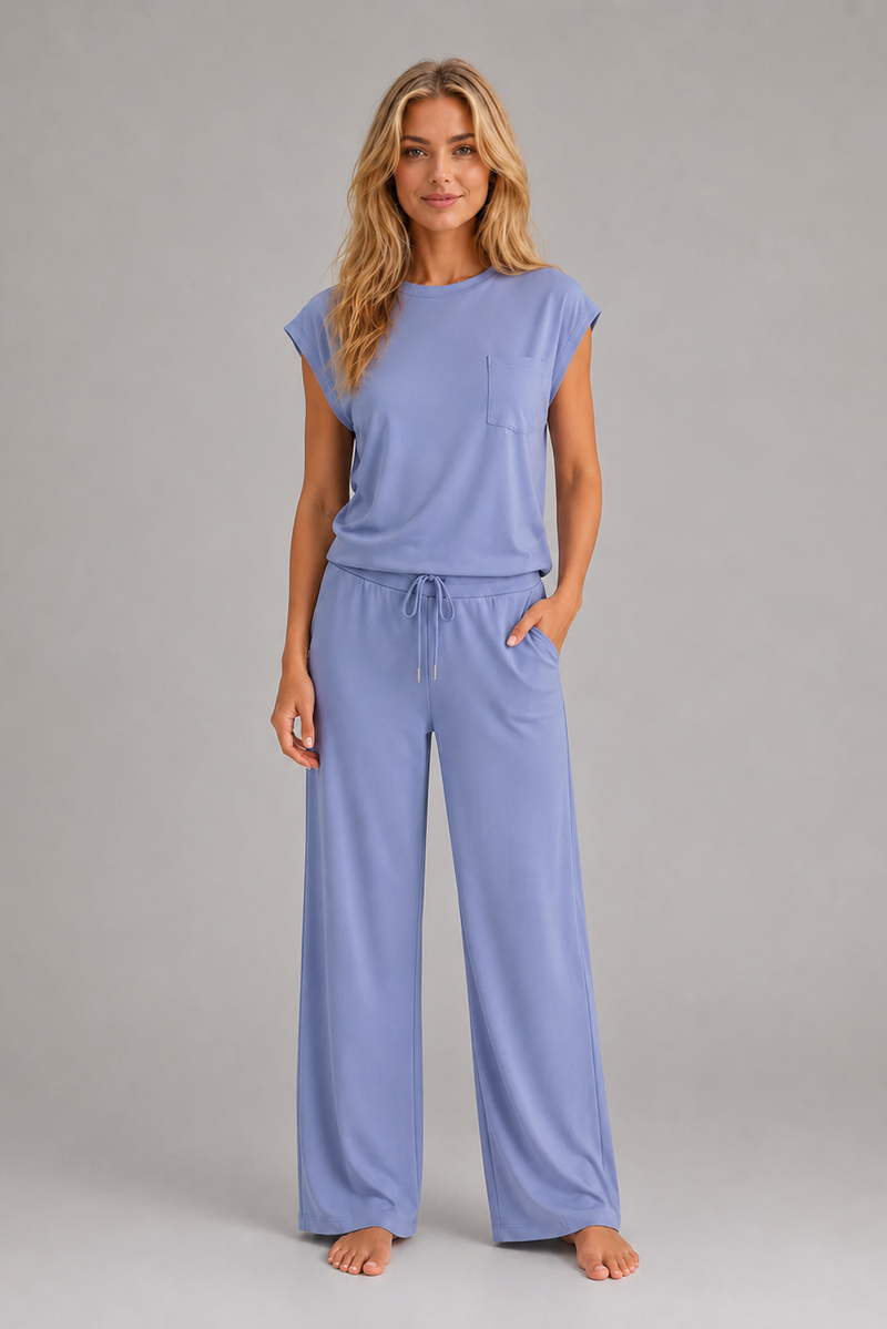 Women's relaxed two-piece lounge set featuring a cap sleeve T-shirt with chest pocket and matching wide leg trousers with an elasticated drawstring waist, crafted from soft breathable fabric for everyday comfort.