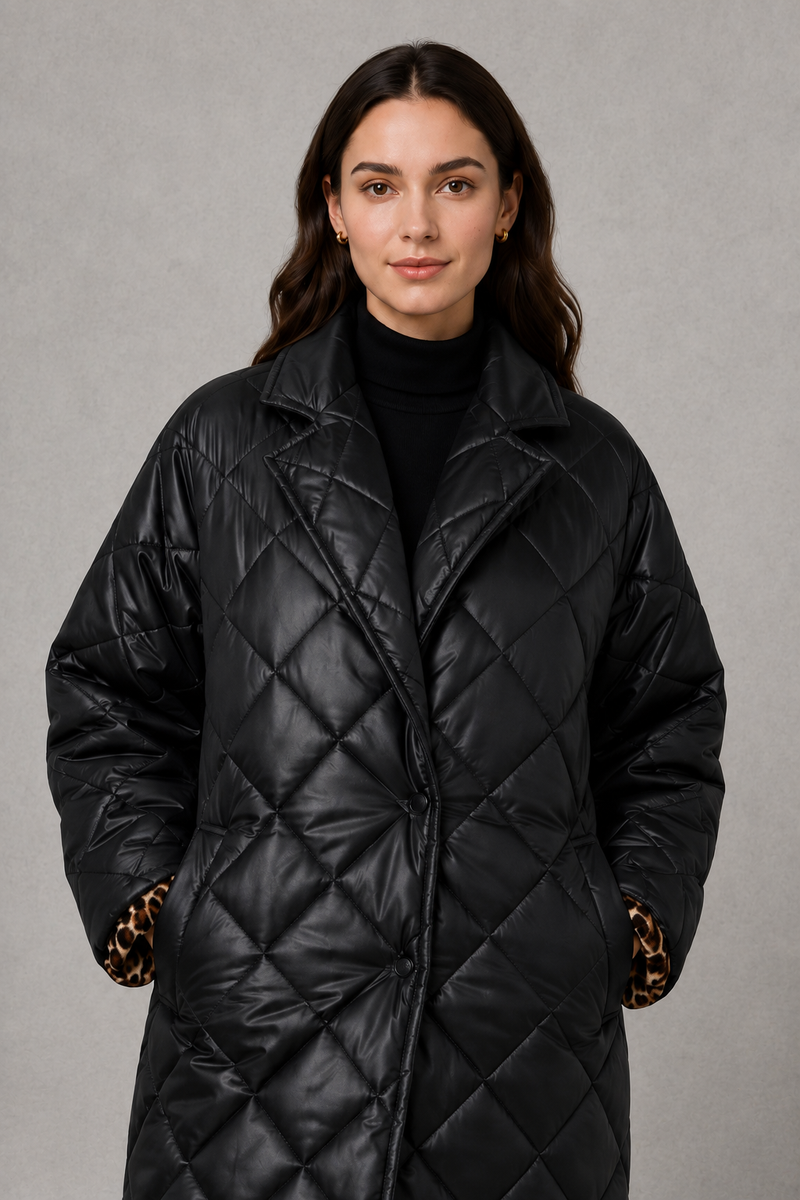Women’s reversible quilted mid-length coat with a classic plain quilted side and bold leopard-print reverse, featuring lapels and side pockets.