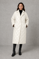 Women’s reversible quilted mid-length coat with a classic plain quilted side and bold leopard-print reverse, featuring lapels and side pockets.