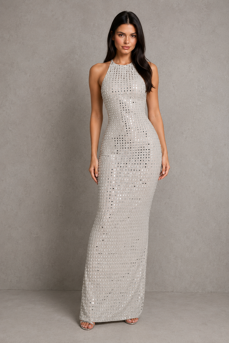 Woman wearing a silver sequin dress against a gray background