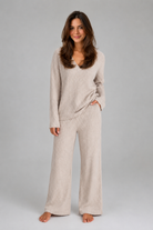 Women's ribbed knit lounge set featuring a relaxed V-neck jumper and matching wide leg trousers in a soft stretch knit, designed for cosy everyday comfort and casual wear.