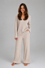 Women's ribbed knit lounge set featuring a relaxed V-neck jumper and matching wide leg trousers in a soft stretch knit, designed for cosy everyday comfort and casual wear.