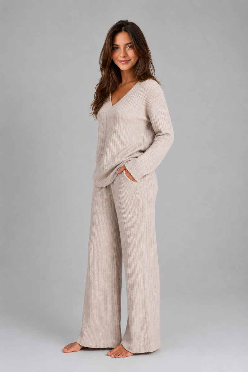 Women's ribbed knit lounge set featuring a relaxed V-neck jumper and matching wide leg trousers in a soft stretch knit, designed for cosy everyday comfort and casual wear.
