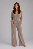 Women's ribbed knit lounge set featuring a relaxed V-neck jumper and matching wide leg trousers in a soft stretch knit, designed for cosy everyday comfort and casual wear.
