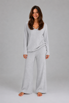 Women's ribbed knit lounge set featuring a relaxed V-neck jumper and matching wide leg trousers in a soft stretch knit, designed for cosy everyday comfort and casual wear.