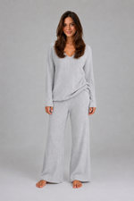 Women's ribbed knit lounge set featuring a relaxed V-neck jumper and matching wide leg trousers in a soft stretch knit, designed for cosy everyday comfort and casual wear.