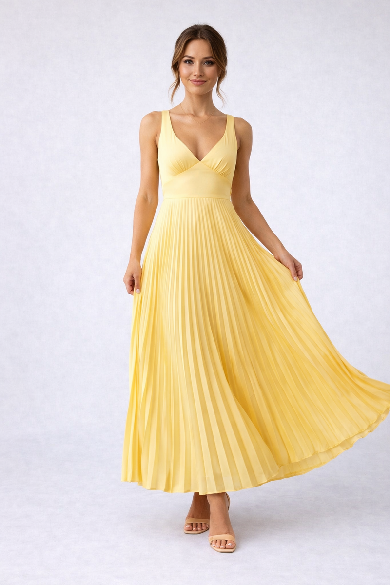 Woman wearing a yellow pleated dress on a white background